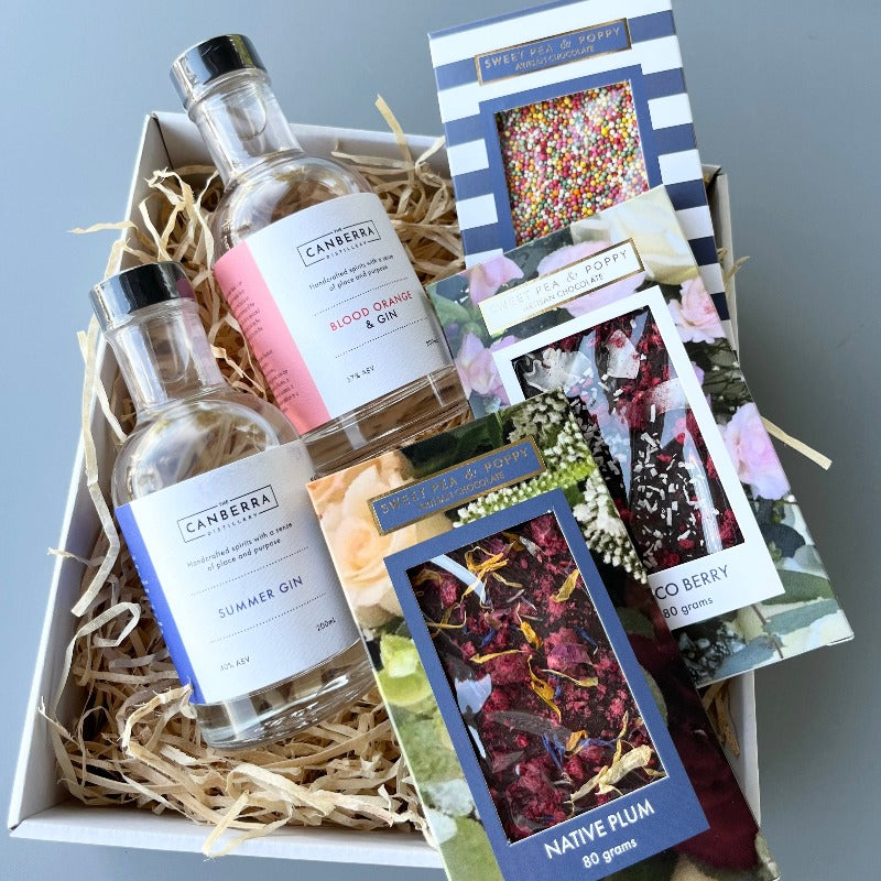 A gift hamper with Sweet Pea & Poppy Native Plum, Coco Berry and Sprinkle fun chocolate bars and The Canberra Distillery Gin