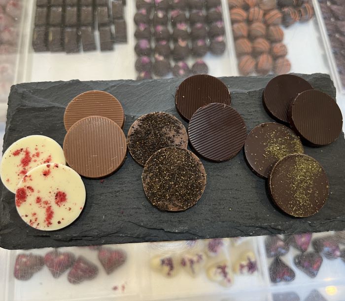 Chocolate tasting discs on a serving board