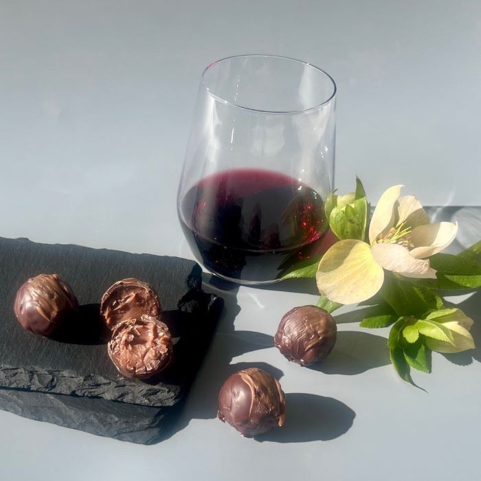 Handmade shiraz chocolate truffles with a glass of shiraz and flowers