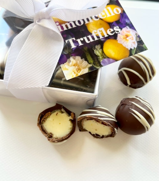 A gift box of limoncello chocolate truffles with a white bow