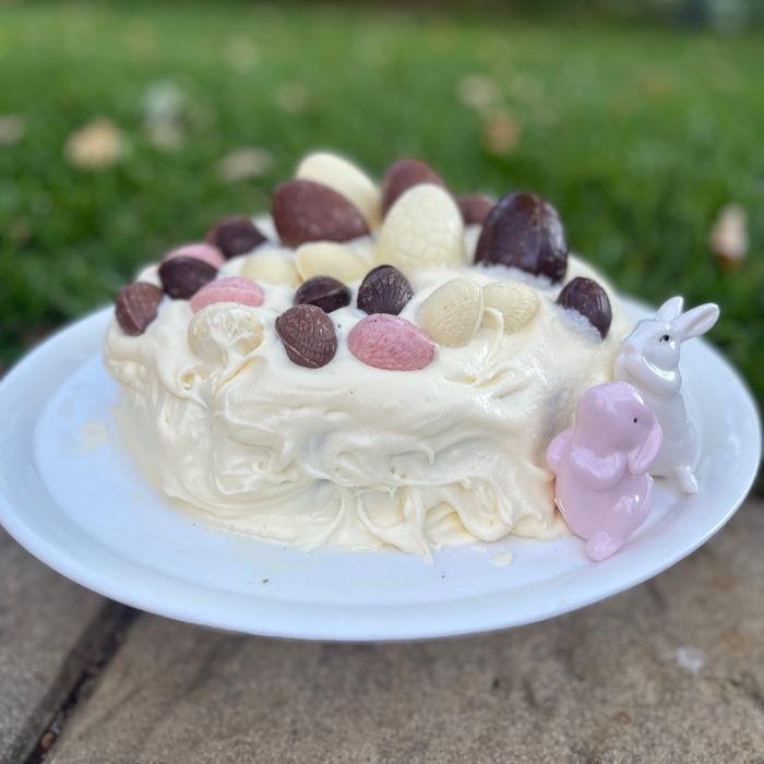 An easter cake decorated with Sweet Pea & Poppy Easter Eggs