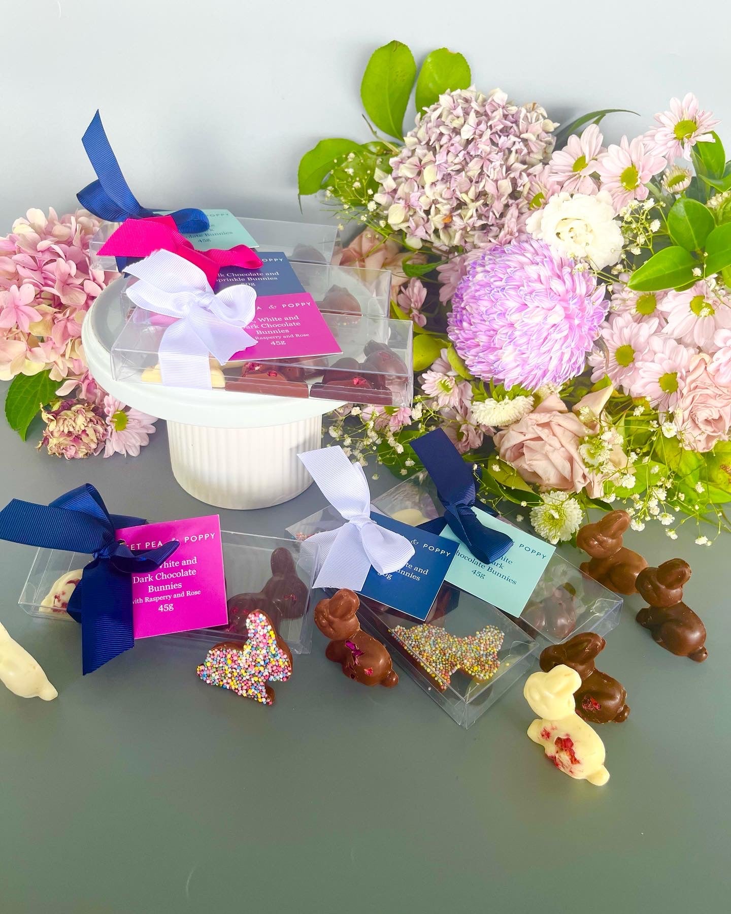 A selection of chocolate Easter bunnies with a floral background