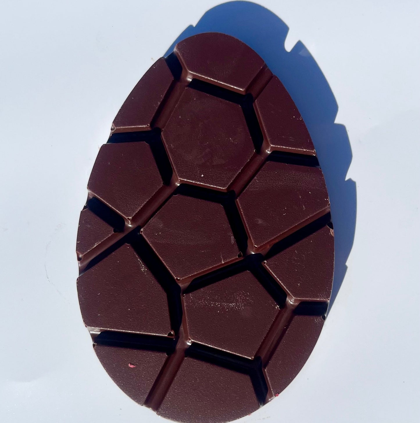 Easter egg shaped Chocolate bar with a unique geometric pattern on a white background