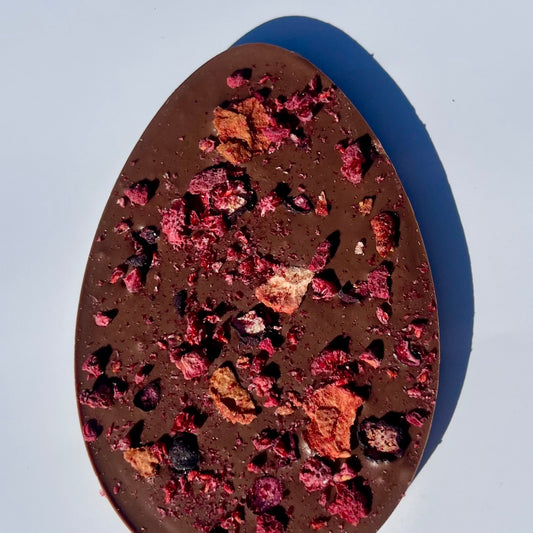 Chocolate bar Easter egg with dried fruit pieces on a white background