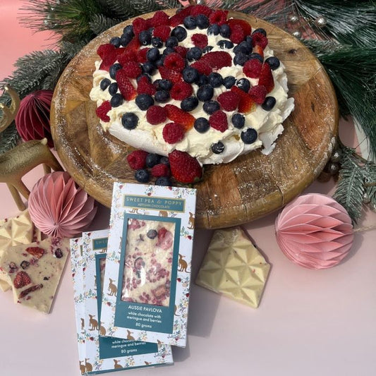 A pavlova dessert with three Sweet Pea & Poppy Aussie Pavlova Artisan Chocolate Bars