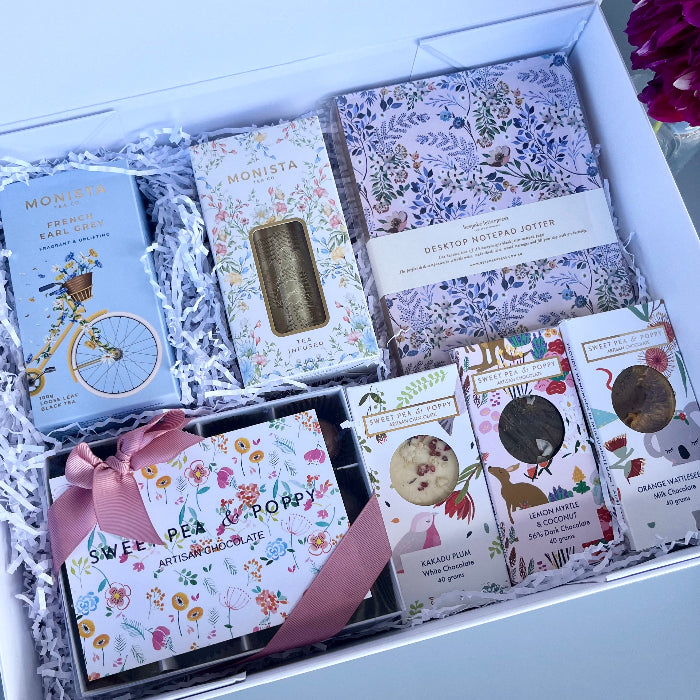 A gift hamper with tea, chocolate and a bespoke journal