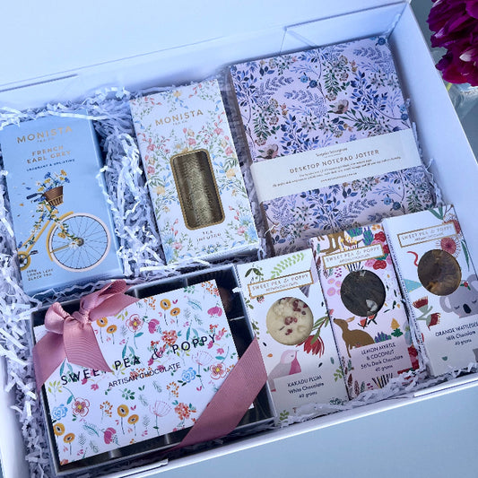 A gift hamper with tea, chocolate and a bespoke journal