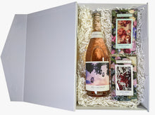 A gift hamper with sparkling rosé wine, a dark chocolate coco berry bar and a white chocolate rosella chocolate bar, presented in a white box with the lid open. 