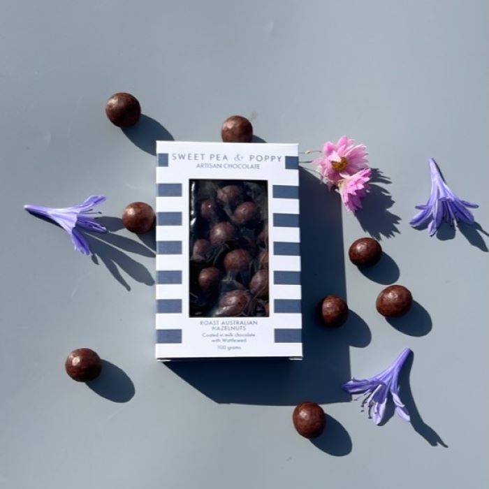 A striped gift box of chocolate coated wattleseed hazelnuts