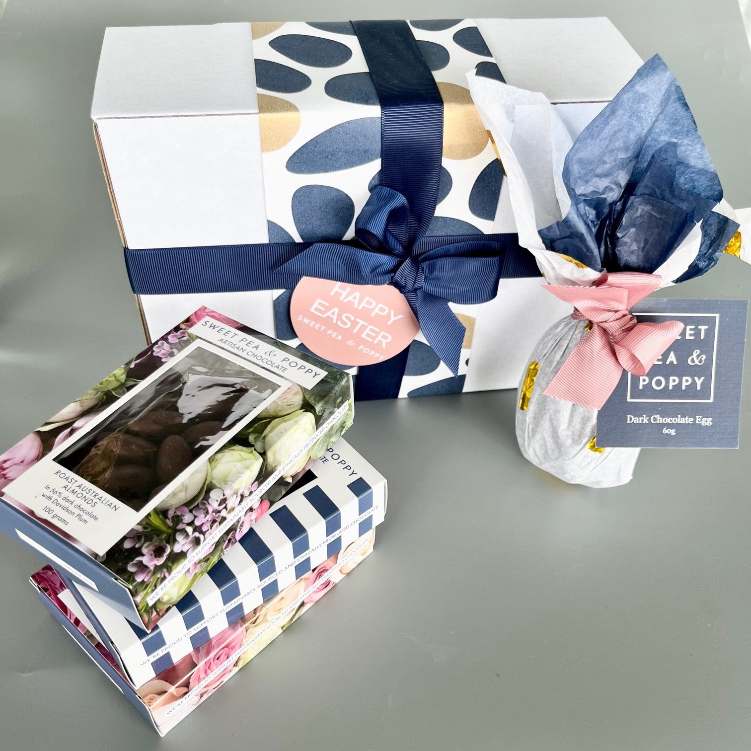 A gift box with boxed chocolate and a chocolate easter egg