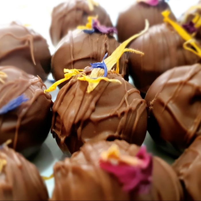 Chocolate honey ganache truffles with edible petal toppings