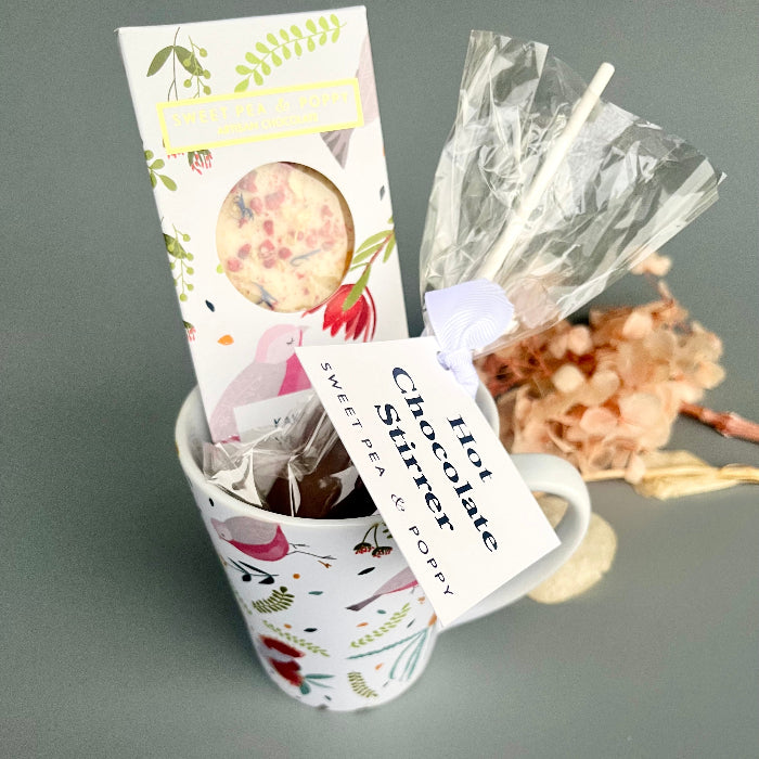 Decorative mug with a chocolate and floral elements on a gray background