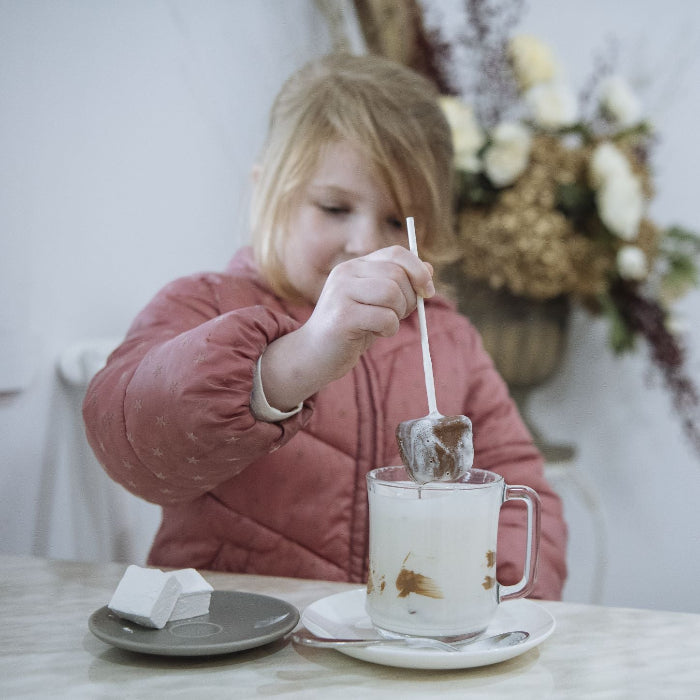 A child enjoying a hot chocolate