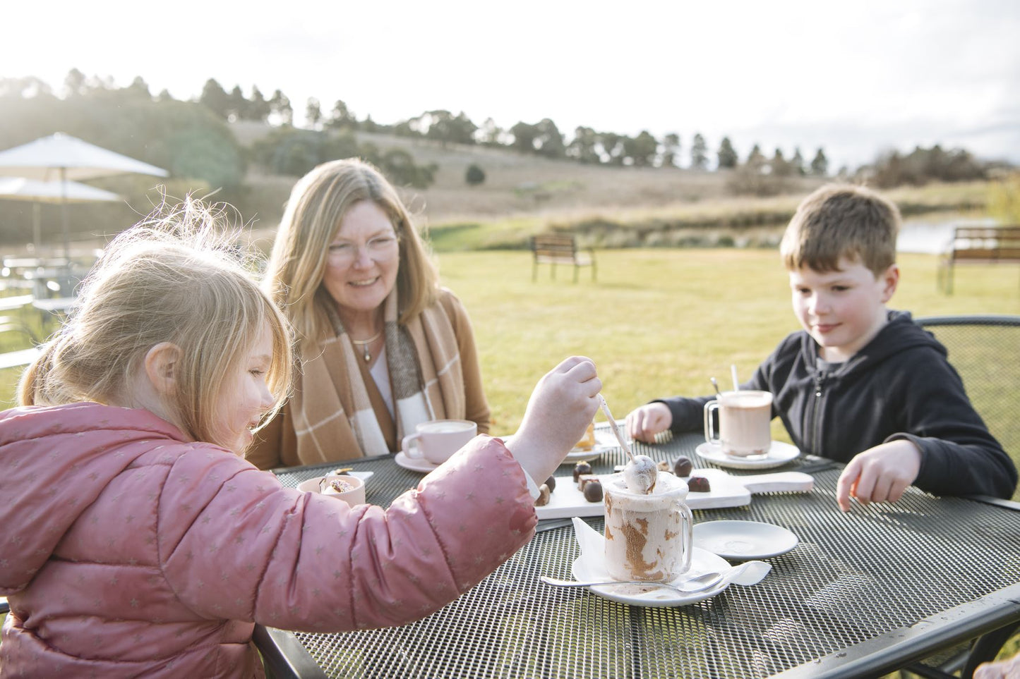 A family enjoying hot chocolate at the Sweet Pea & Poppy Chocolate Cafe
