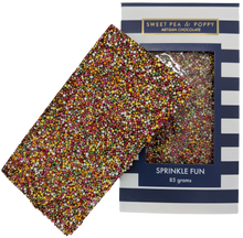 A picture of a milk chocolate Sprinkle Fun bar on top on a packaged milk chocolate Sprinkle Fun bar