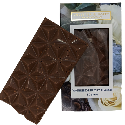 A milk chocolate Wattleseed Espresso Almond  chocolate bar sitting on top of a packaged Wattleseed Espresso Almond chocolate ba