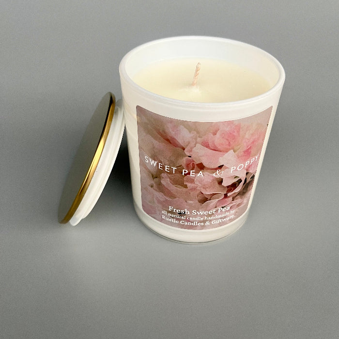 Candle with floral label on a gray background