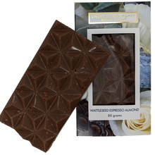 A picture of a milk chocolate Espresso Almond Wattleseed bar on top on a packaged milk chocolate, espresso almond wattleseed chocolate bar