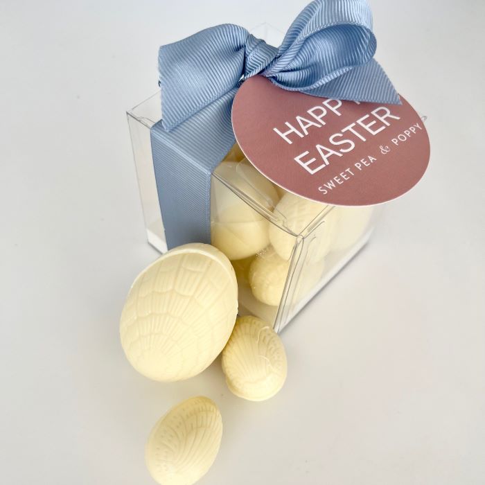 A gift box of white chocolate Easter eggs with a ribbon bow